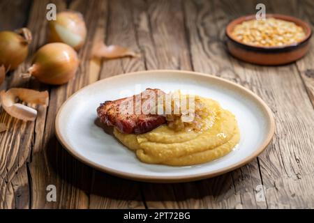 Tschechische Küche, geräuchertes Fleisch mit Erbsenbrei und gebratene Zwiebel bis golden Stockfoto