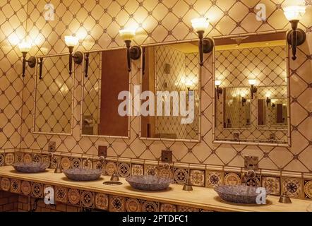 Dekorative, blau gemusterte Waschbecken mit Spiegeln und Lampen im Paris Las Vegas Hotel and Casino in Las Vegas, Nevada, USA. Stockfoto