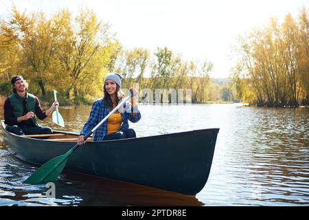 Er hat mein Herz mit einer Kanufahrt gewonnen. Porträt eines jungen Paares, das eine Kanufahrt auf dem See macht. Stockfoto