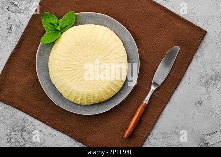 Blick von oben auf den Adyghe-Käse auf dem Teller Stockfoto