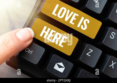 Textunterschrift Presenting Love is Here, Wort geschrieben auf Romantisches Gefühl schöne Emotion positiver Ausdruck Care Joy Stockfoto