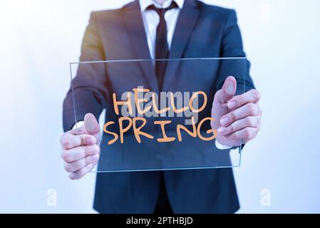 Schild mit der Aufzeigung Hallo Frühling, Geschäftsansprache Begrüßung der Saison nach der Winterblüte der Blumen Stockfoto