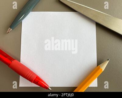 Kleine quadratische Papierstücke für Notizen und Notizen auf dem Schreibtisch und Kugelschreiber mit Bleistiften. Geschäftsarbeit. Stockfoto