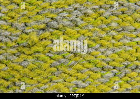 Hellgrüner Hintergrund von Strickpullover im Nahbereich Stockfoto