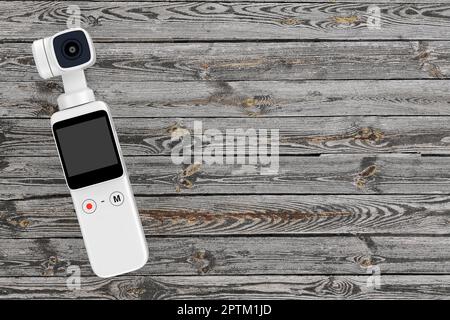 Handheld Gimbal Action-Kamera im Taschenformat auf einem Holztisch mit Planke. 3D-Rendering Stockfoto