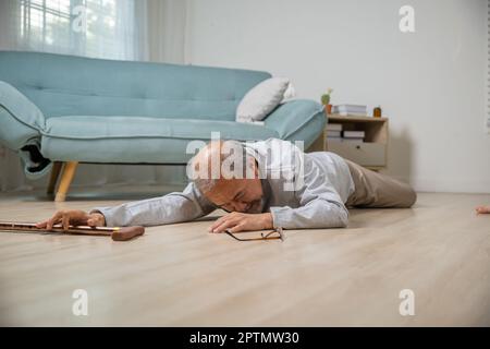 Älterer Senioren Kopfschmerzen, die nach dem Sturz auf dem Boden lagen, Schmerzen und Schmerzen durch Osteoporose, älterer Mann, der allein mit Gehhilfe auf den Boden fällt Stockfoto