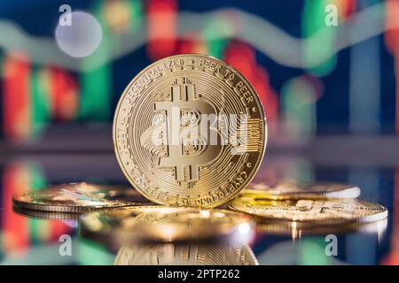Bitcoins mit Hintergrund und roter und grüner digitaler Krypto-Kerzenleuchtenkarte Stockfoto