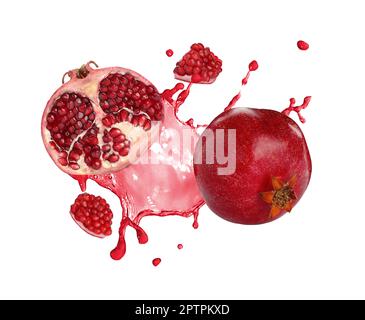 Frische reife Granatäpfel und ein Spritzer Saft auf weißem Hintergrund Stockfoto