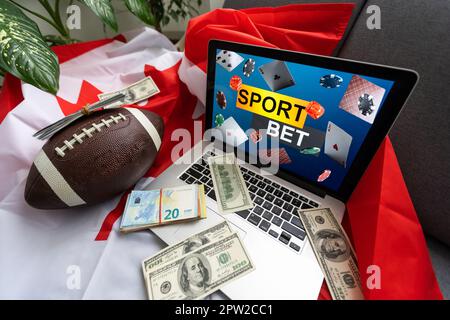 Laptop mit Sportwetten und kanadischer Flagge Stockfoto