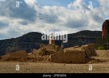 Vilanova de Sau, Spanien - 27. April 2023: Der freiliegende Glockenturm der Stadt ist am Sau Wasserreservoir zu sehen. Die Wasserreservoirs, eine der wichtigsten Wasserquellen der spanischen Region Katalonien und insbesondere der Stadt Barcelona, sind nach Angaben der katalanischen Wasserbehörde zu 6 % ausgelastet, während die Wasserreservoirs der Region zu 27 % ausgelastet sind. Die die lokale Regierung gezwungen hat, Maßnahmen gegen die Wasserknappheit zu ergreifen, da Spanien in eine Phase der chronischen Dürre eingetreten ist. Der rekordverdächtige Tiefstand hat die Stadt Sant Romà mit ihrem berühmten Glockenturm, der fl Stockfoto