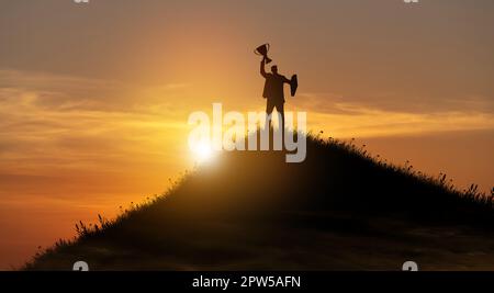Silhouette Sieg Geschäftsmann mit Trophäe kletterte auf die Spitze des Berges über den Himmel und Sonnenlicht Hintergrund. Erfolg, Zielerreichung, Führung, Stockfoto