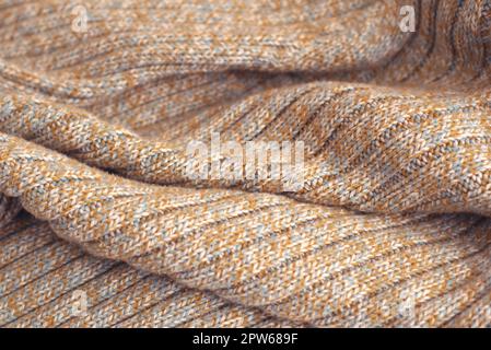 Meliert beige gestrickten Wollpullover. Textur Detail Nahaufnahme. Stockfoto