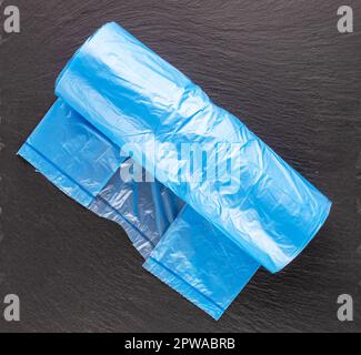 Eine Packung Müllsäcke aus Kunststoff auf Schieferstein, Makro, Draufsicht. Stockfoto