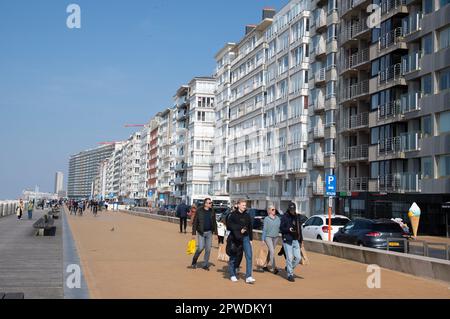 Menschen, die an der Strandpromenade in Ostende, Belgien, entlang der Nordsee Sport treiben und spazieren gehen. Stockfoto