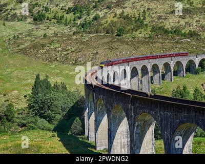 Glenfinnan, Schottland - 05 29 2018: Berühmte jacobite-Dampfeisenbahn, die das Glenfinnan-Viadukt im schottischen Hochland überquert. Stockfoto