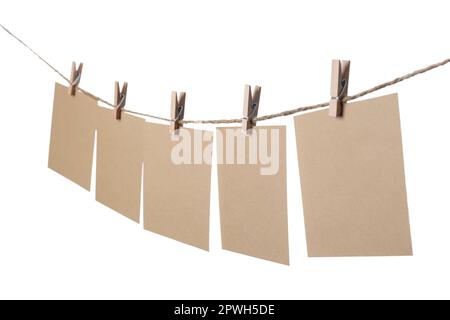 Kleidung mit leeren Notizbüchern auf Schnur vor weißem Hintergrund. Platz für Text Stockfoto