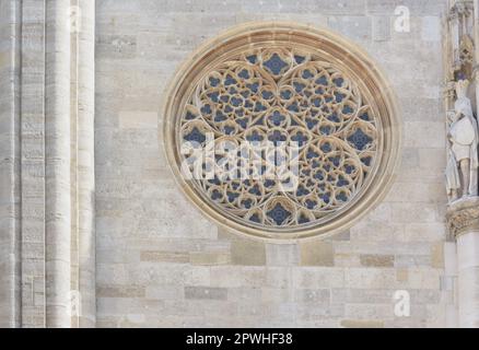 Gotisches rundes Fenster vor der Steinmauer von St. Stephansdom in Wien im horizontalen Format Stockfoto