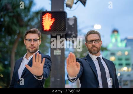 Geschäftsleute hören auf, mit der Hand zu singen. Warnausdruck mit negativer und schwerwiegender Geste. Hören Sie auf mit der Hand, der Geschäftsmann sagt, warten Sie. Geschäftsmann Stockfoto