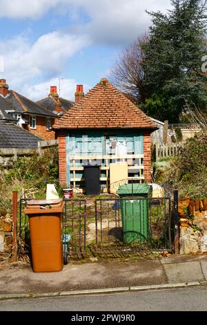 Eine alte Garage, die ein Grundstück zwischen Häusern besetzt, das für Immobilienentwickler von Wert wäre, Southborough, Kent. Stockfoto