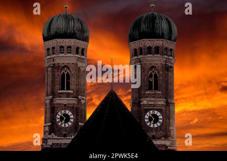 Die Silhouette der beiden Türme der Frauenkirche in München vor dem dramatischen Dämmerhimmel Stockfoto