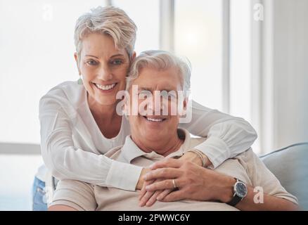 Er gehört ganz mir. Verkürztes Porträt eines liebevollen älteren Paares, das sich zu Hause im Wohnzimmer entspannt Stockfoto