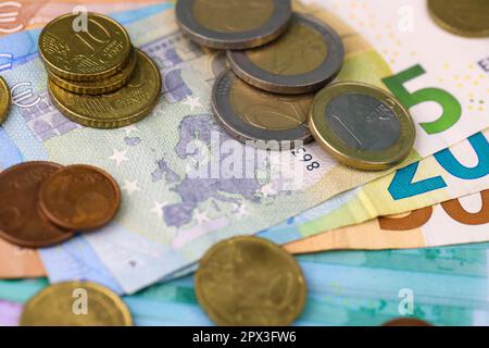 Euro-Geldscheine und -Münzen schließen sich. Große Menge an Euro-Geld auf dem Tisch. Geschäfts- und Budgetkonzept Stockfoto