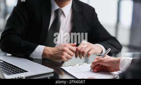 Verkaufsleiter, der Ratschläge erteilt, Antragsformular, in dem das Angebot eines Hypothekarkredits für die Auto- und Hausversicherung berücksichtigt wird. Stockfoto