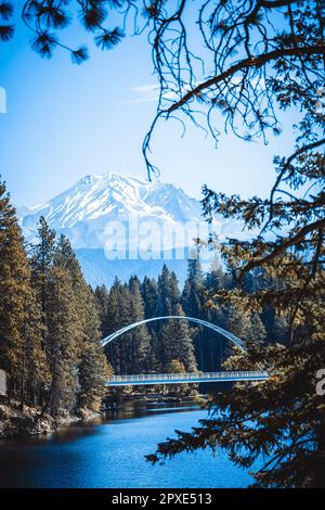 Die Fußgängerbrücke Wagon Creek in Siskia County, Kalifornien, ist mit majestätischen Bergen im Hintergrund ein atemberaubendes Bild Stockfoto