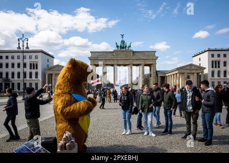 Touristen und Berliner Bären mit ukrainischer Flagge auf dem Pariser Platz vor dem Brandenburger Tor, Berlin. Touristen und Berliner Baer mit ukrainisc Stockfoto