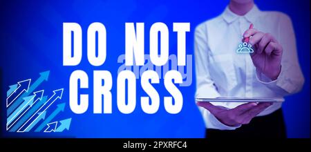 Textzeichen mit der Aufschrift „Do Not Cross, Business overview Crossing is Forbidden Dangerous Guidance warning to not do it.“ Stockfoto