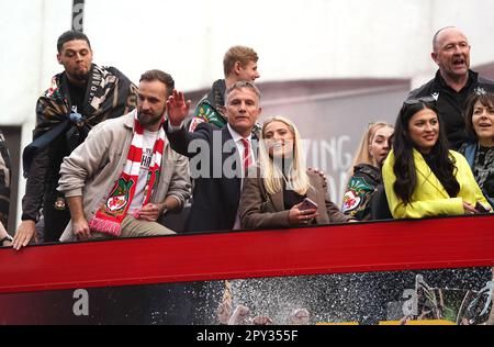 Wrexham Manager Phil Parkinson (Zentrum) feiert in einem Bus mit offenem Oberdeck während einer Siegesparade in Wrexham, Wales. Foto: Dienstag, 2. Mai 2023. Stockfoto