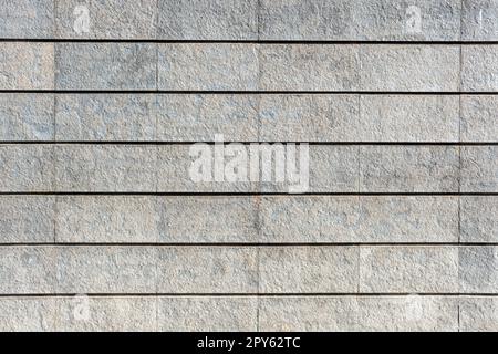 Hintergrund von einer Wand aus grauen Granitsteinen Stockfoto