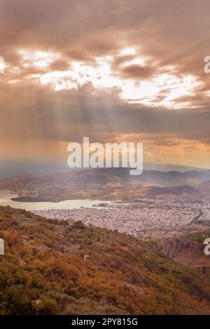 Die Stadt, das Meer Golf von Volos Luftaufnahme von Pelion und Sonnenstrahlen durch die Wolken, Griechenland Stockfoto
