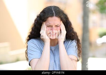 Frau mit Migräne auf der Straße Stockfoto