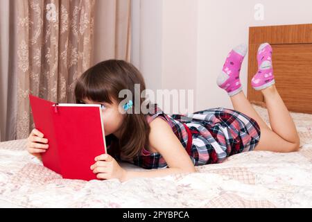 Kleines Mädchen, ein Buch zu Hause Stockfoto