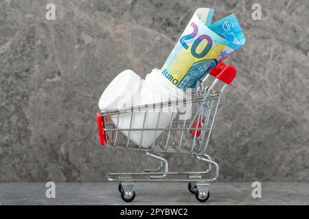 Pillen-Flasche mit 20 Euro in einem Warenkorb Stockfoto