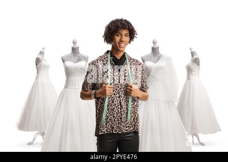 afroamerikanischer Modedesigner mit einem Maßband vor Brautkleidern isoliert auf weißem Hintergrund Stockfoto
