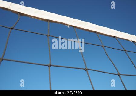 Volleyballsport, das Netz gegen die Nahaufnahme des blauen Himmels aufteilt. Outdoor-Sport Stockfoto