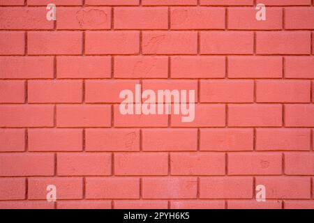 Hintergrund einer roten Steinmauer Stockfoto