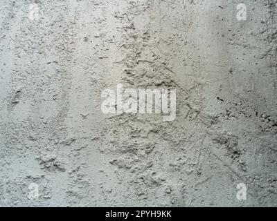 Hintergrund und Textur von Zementplatten. Ungleichmäßig gespannter Zement. Raue graue Betonwand. Stockfoto