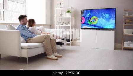 Rückansicht Eines Paares, das sich einen Film im Fernsehen ansieht Stockfoto