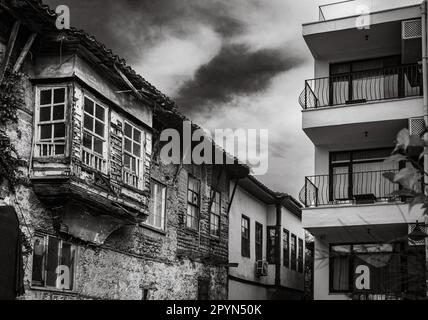 Antalya, Türkei - Dieses Foto zeigt den Kontrast zwischen dem traditionellen osmanischen Haus und dem modernen Apartmentgebäude in Kaleici, dem Stockfoto