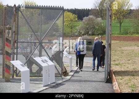 04. Mai 2023, Bayern, Töpen: Besucher gehen durch ein ehemaliges Grenztor am Deutsch-Deutschen Museum Mödlareuth. In Zukunft wird eine Erweiterung dem Museum ermöglichen, die Geschichte der deutschen Teilung und Wiedervereinigung anhand des Beispiels Mödlareuth zu erzählen, basierend auf den neuesten Forschungsergebnissen. Foto: Bodo Schackow/dpa Stockfoto