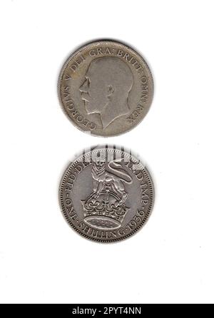 King George V, eine alte Schilling-Münze aus Großbritannien, die vorne und hinten zeigt. Stockfoto