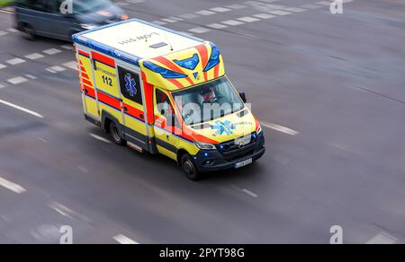 Leipzig, Deutschland. 23. März 2023. Ein Krankenwagen nähert sich der Kreuzung Mecklenburger Straße, Lagerhofstraße, Friedrich-List-Platz mit blinkenden blauen Lichtern. Die Polizei hat an der Kreuzung zwischen 2020 und 2022 insgesamt 98 Verkehrsunfälle registriert. Dies macht die Kreuzung zu einer der unfallgefährlichsten Kreuzungen in der Stadt. Verschiedene Maßnahmen sollen nun die Unfallgefahr verringern. Kredit: Jan Woitas/dpa/Alamy Live News Stockfoto