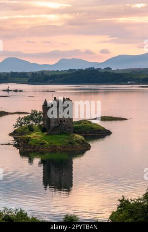 Castle Stalker auf Loch Laich mit Wasserreflexionen bei Sonnenuntergang, Argyll, Schottland, Großbritannien Stockfoto