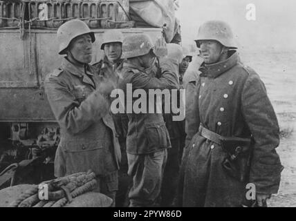 Schützen während einer Pause in der Action abfeuern. Im Hintergrund ein Traktor. Foto. Gemini [maschinelle Übersetzung] Stockfoto
