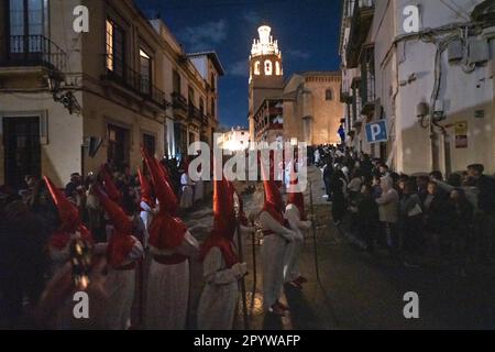 Cofradias tragen rote konische Kapuzen während der Mitternachtsstummprozession am Karfreitag in der Heiligen Woche oder Semana Santa, 6. April 2023 in Ronda, Spanien. Ronda, die sich im 6. Jahrhundert v. Chr. niedergelassen hat, hält seit über 500 Jahren Heilige Woche-Prozessionen ab. Stockfoto