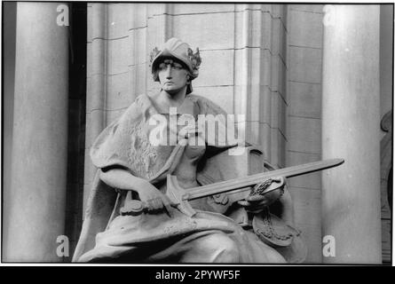 Berlin, Bezirk Moabit. Bezirksgericht Moabit, Turmstraße (erb. 1902–1906, Arch.: Paul Thoemer und Jean Fasquel, Neobarock). Teilansicht: Göttin Justitia als Sandsteinskulptur, allegorische Figur über dem Hauptportal. Blick auf die historische Stadt, schwarz-weiß. Foto, 1995. Stockfoto