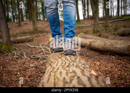 Nahaufnahme eines Mannes, der auf dem Land entlang eines Holzkörpers läuft. Stockfoto